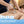 A close-up of a person receiving a targeted fascia release massage, with a therapist using a handheld metal scraping device on the upper back. The image includes three feature icons and text reading 'Targeted Fascia Release' at the bottom.