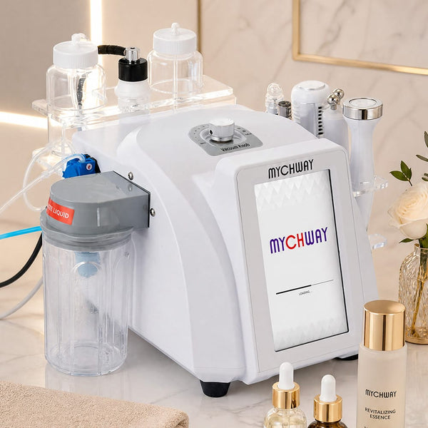 A white MYCHWAY skincare device with a digital display screen, connected to multiple clear and gray accessory bottles and tubes on a marble countertop. The MYCHWAY logo is visible on the device and a bottle in the foreground.