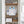 MYCHWAY 8-in-1 hydro dermabrasion machine stored neatly on a bathroom cabinet shelf alongside folded towels and skincare products, demonstrating compact at-home storage
