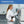 Woman in a lab coat holding a professional-grade air pump in a laboratory setting.