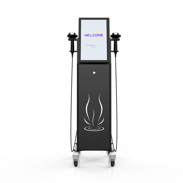 A black freestanding beauty device on wheels with a large front display screen, two handheld applicator handles connected by cords, and a white steam-like graphic on the lower cabinet. The screen shows the word WELCOME in purple text.