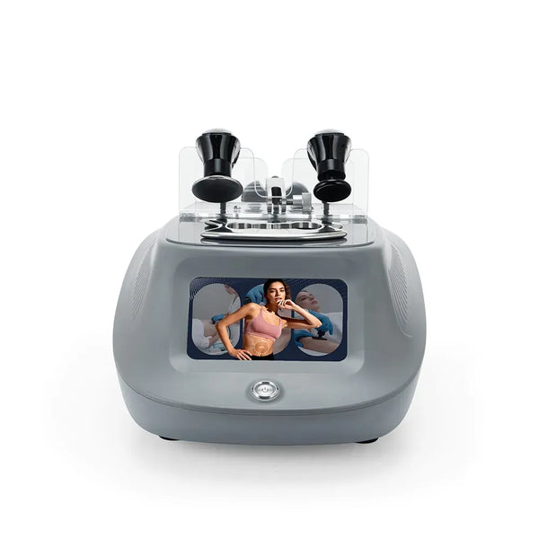 A gray beauty device with two black treatment heads under a clear cover and a front display screen showing a woman, photographed on a white background.
