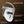 A white and silver LED face mask with adjustable straps, shown on a dark brown gradient background with text highlighting ergonomic design, breathable design, lightweight straps, and full coverage eye pads.
